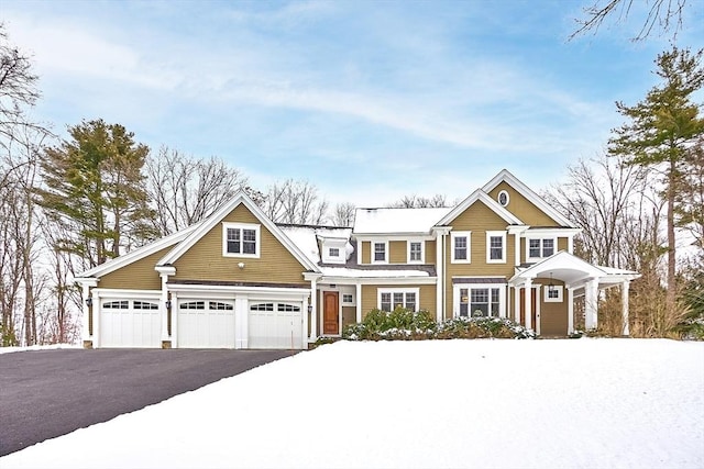 view of front facade with a garage and aphalt driveway