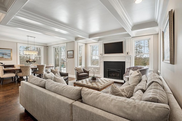 living room featuring dark wood-type flooring, plenty of natural light, coffered ceiling, and a fireplace