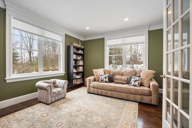 living area featuring dark wood-style floors, baseboards, ornamental molding, and recessed lighting