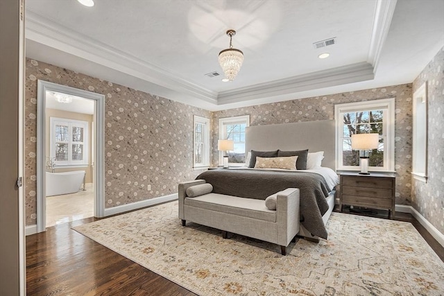 bedroom with ornamental molding, wood finished floors, visible vents, and wallpapered walls