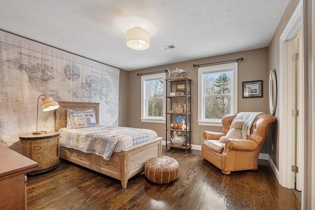 bedroom featuring dark wood-style floors, visible vents, and baseboards