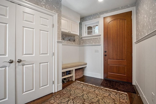 mudroom featuring a wainscoted wall, dark wood-style flooring, and wallpapered walls