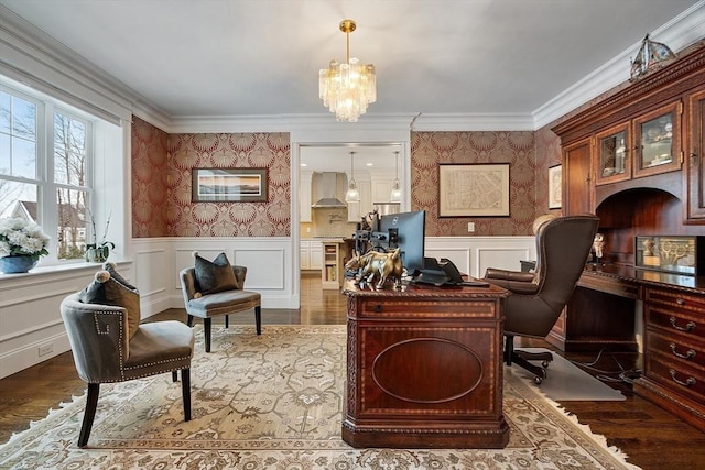 office area featuring a wainscoted wall, a decorative wall, wood finished floors, and wallpapered walls