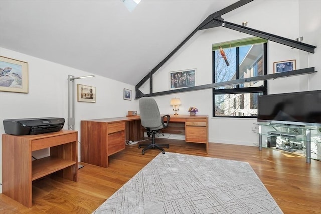 office with lofted ceiling and wood finished floors