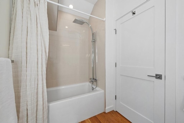 bathroom with shower / bath combo and wood finished floors