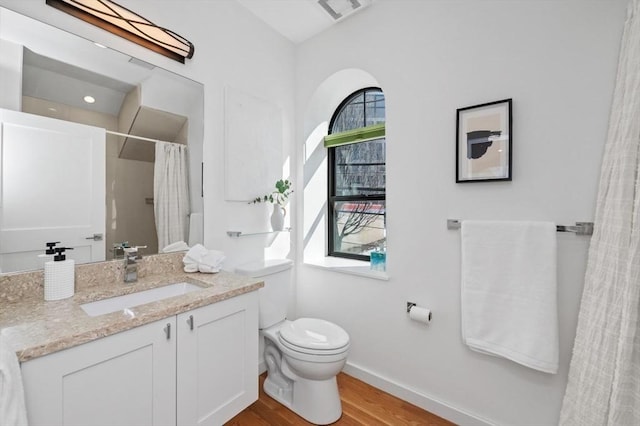 full bathroom featuring curtained shower, toilet, vanity, wood finished floors, and baseboards