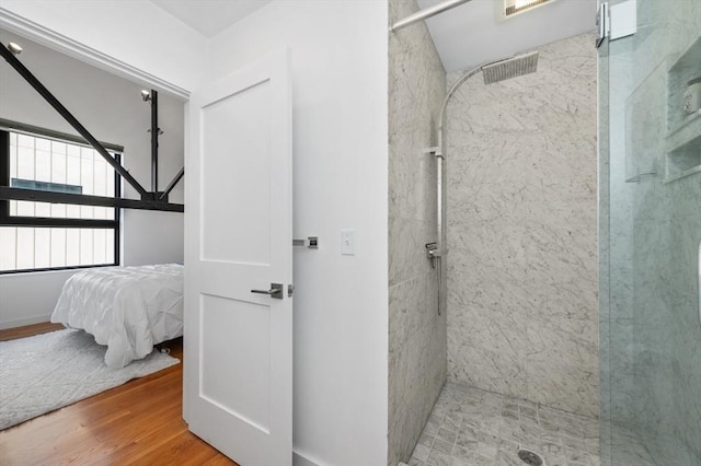 ensuite bathroom with wood finished floors, walk in shower, ensuite bath, and visible vents