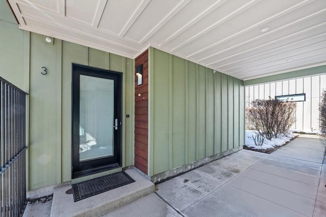 view of exterior entry featuring board and batten siding