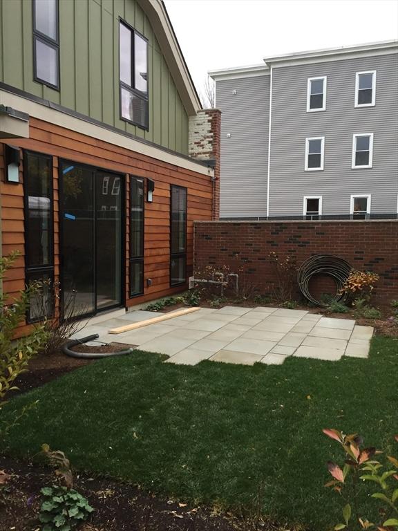 back of house featuring a lawn and board and batten siding