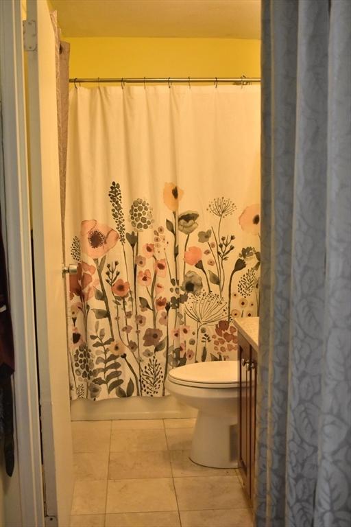 full bath featuring tile patterned flooring, toilet, and vanity