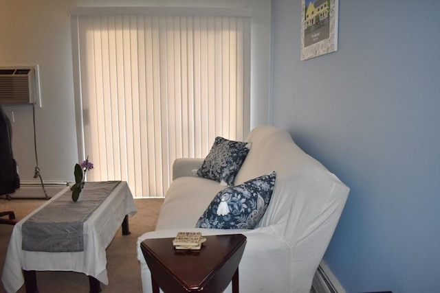 living area featuring baseboard heating, carpet flooring, and a wall unit AC