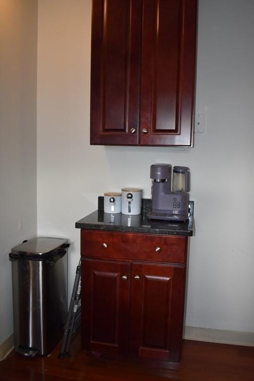 bar with baseboards and dark wood-style flooring