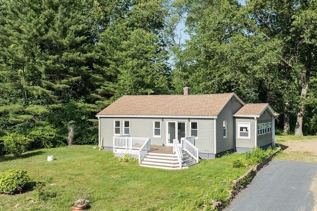 759 Millers Falls Rd, Northfield, MA 01360 - view of front of house featuring a front lawn, a wooden deck, roof with shingles, and a chimney