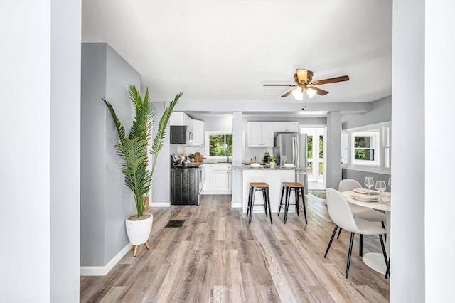 759 Millers Falls Rd, Northfield, MA 01360 - kitchen featuring ceiling fan, white cabinetry, a kitchen island, and light wood-type flooring
