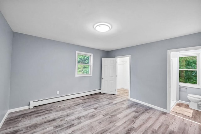 759 Millers Falls Rd, Northfield, MA 01360 - unfurnished bedroom featuring baseboard heating, wood finished floors, and ensuite bathroom