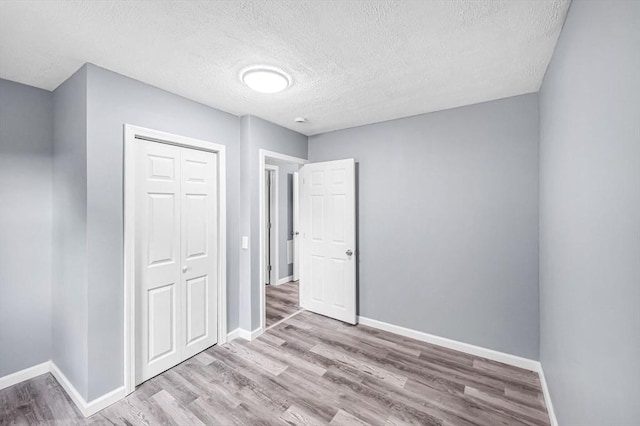 759 Millers Falls Rd, Northfield, MA 01360 - unfurnished bedroom with wood finished floors, a textured ceiling, and a closet