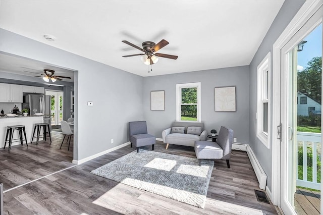 759 Millers Falls Rd, Northfield, MA 01360 - living area featuring a ceiling fan, wood finished floors, and a baseboard radiator