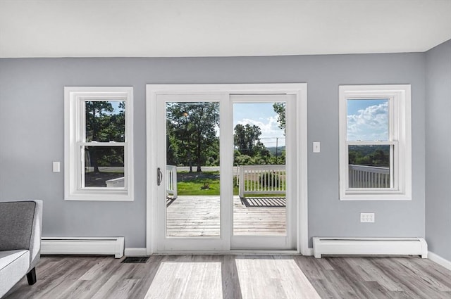 759 Millers Falls Rd, Northfield, MA 01360 - doorway to outside with a baseboard heating unit and wood finished floors