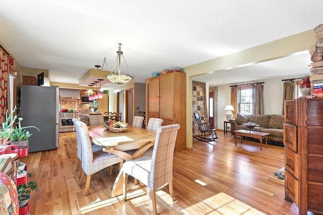 dining space with light wood-type flooring