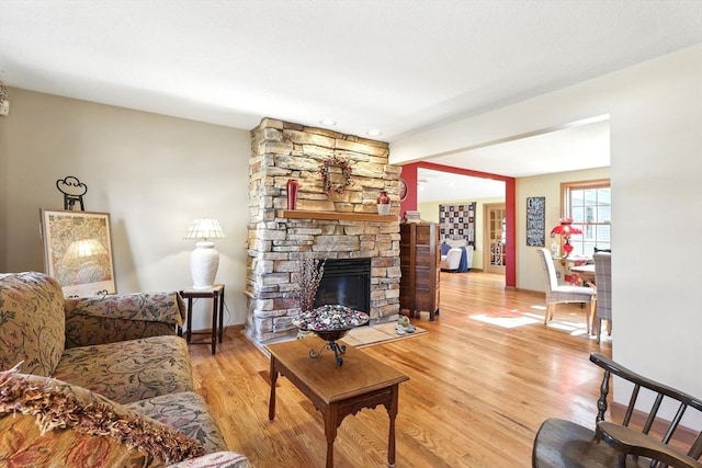 living room featuring a fireplace and light wood finished floors