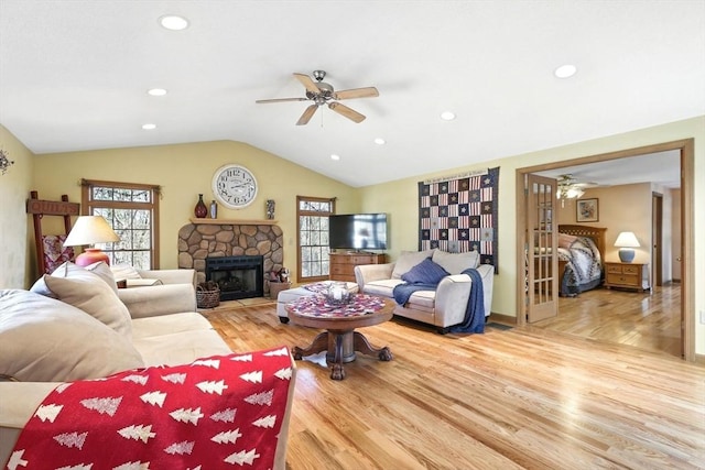 living area featuring wood finished floors, a fireplace, recessed lighting, ceiling fan, and vaulted ceiling