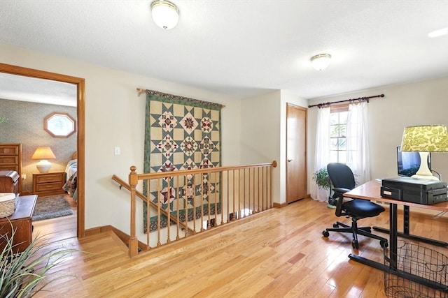 office featuring baseboards and light wood-type flooring