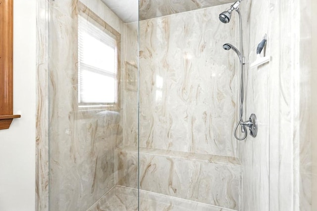 bathroom with a marble finish shower