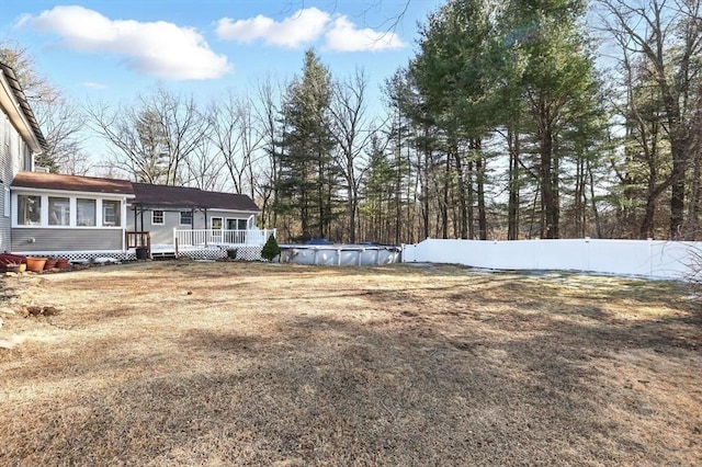 view of yard featuring a fenced backyard, a fenced in pool, and a deck