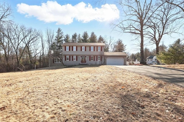 colonial house with driveway and a garage