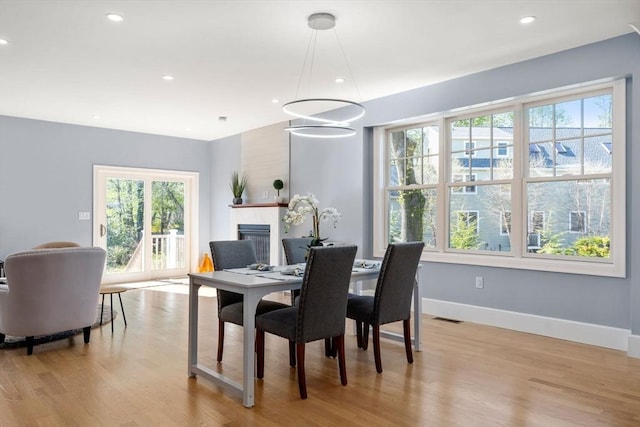 dining room featuring recessed lighting, baseboards, visible vents, and light wood-style floors