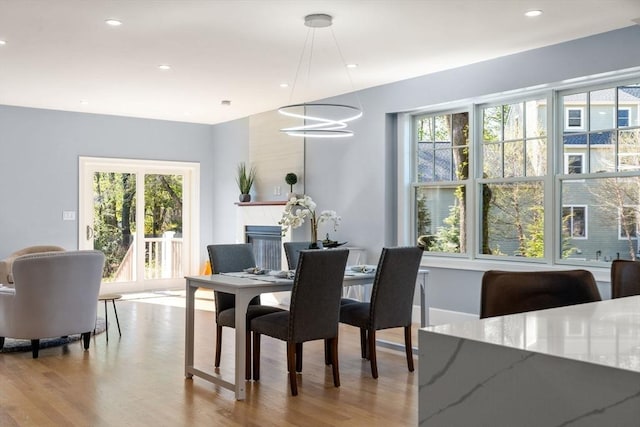 dining space featuring recessed lighting, wood finished floors, and a healthy amount of sunlight