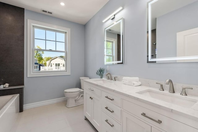 bathroom with a sink, baseboards, toilet, and visible vents