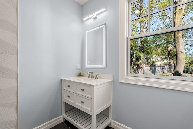 bathroom featuring baseboards and vanity