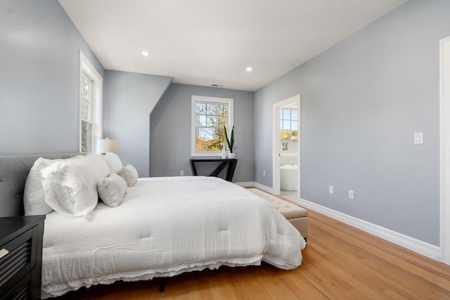 bedroom with baseboards, recessed lighting, wood finished floors, and multiple windows
