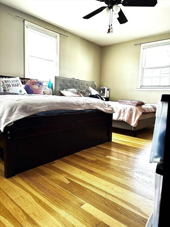 bedroom featuring light wood-type flooring and a ceiling fan