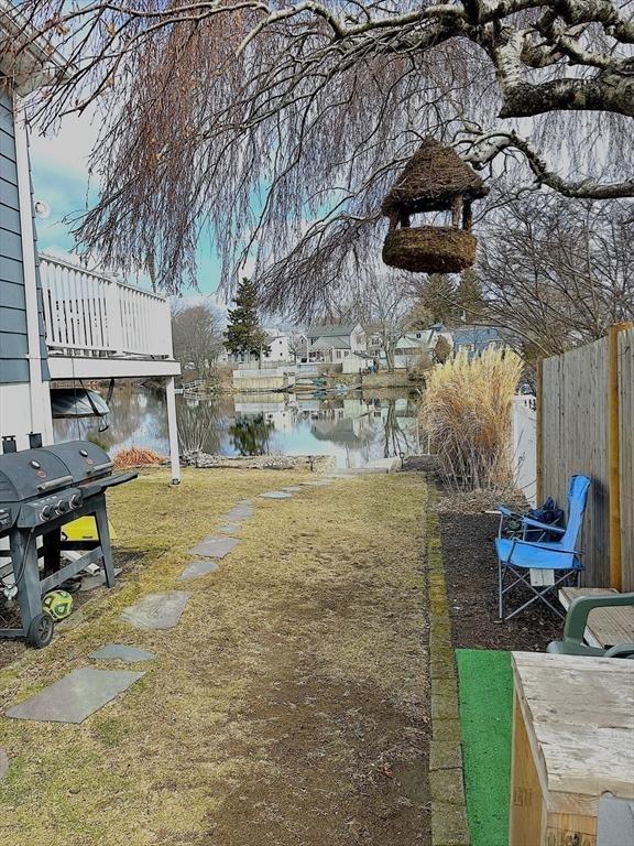 view of yard with fence and a water view