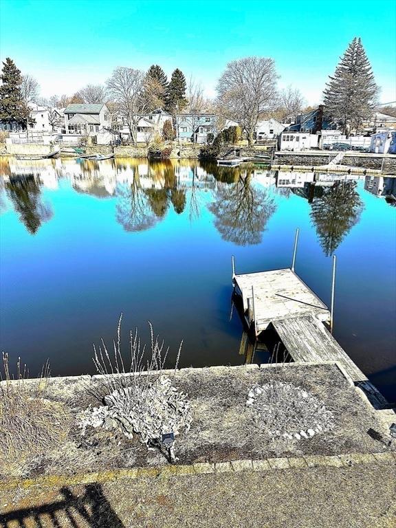 dock area with a water view and a residential view