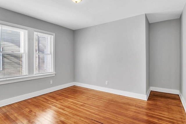 unfurnished room with wood finished floors and baseboards