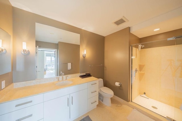 bathroom featuring toilet, visible vents, tiled shower, and vanity