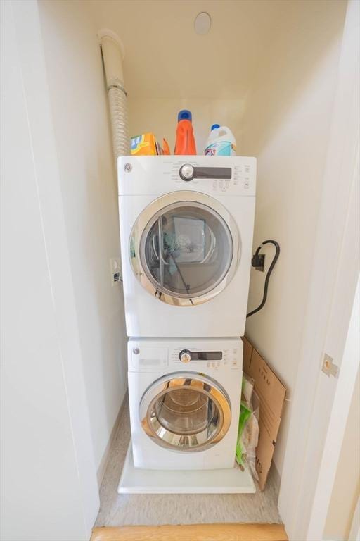 laundry area featuring laundry area and stacked washer / dryer