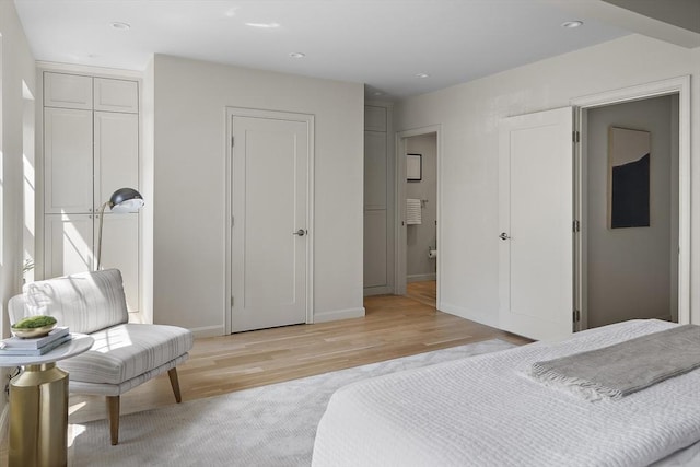bedroom with light wood finished floors, baseboards, and recessed lighting