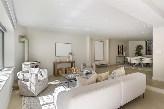 living area with a wood stove, baseboards, and recessed lighting