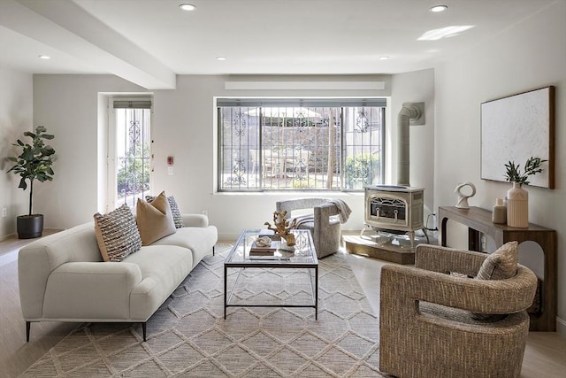living room featuring a wood stove and recessed lighting