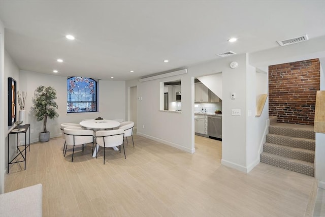 dining room with recessed lighting, light wood-style floors, stairway, and baseboards