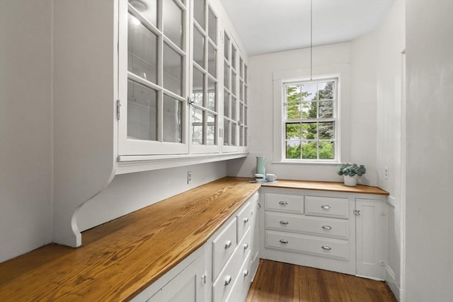 33 Wellington Ln, Belmont, MA 02478 - interior space with wood counters, white cabinetry, glass insert cabinets, and dark wood-type flooring
