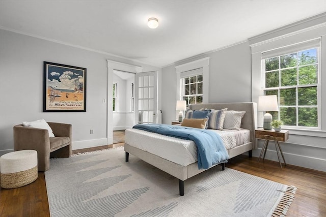 33 Wellington Ln, Belmont, MA 02478 - bedroom featuring multiple windows, baseboards, ornamental molding, and wood finished floors