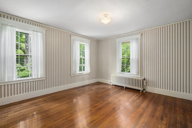 33 Wellington Ln, Belmont, MA 02478 - unfurnished room featuring radiator heating unit, wood finished floors, and baseboards