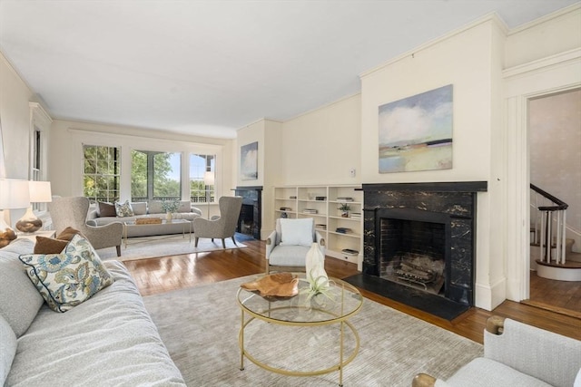 33 Wellington Ln, Belmont, MA 02478 - living area featuring a premium fireplace, wood finished floors, crown molding, and stairs