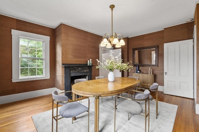 33 Wellington Ln, Belmont, MA 02478 - dining area featuring baseboards, wood finished floors, a chandelier, and a fireplace