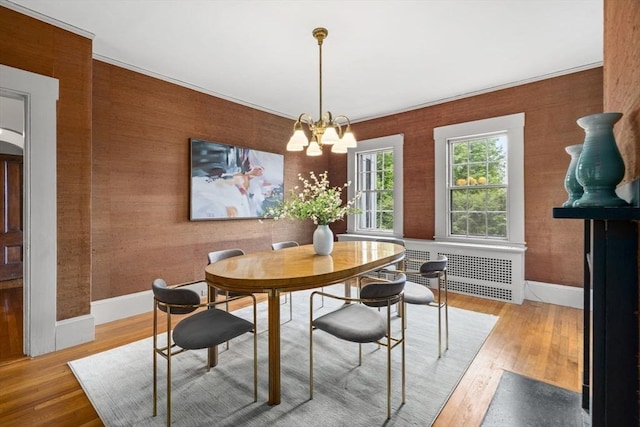 33 Wellington Ln, Belmont, MA 02478 - dining area with radiator, hardwood / wood-style flooring, a chandelier, and baseboards